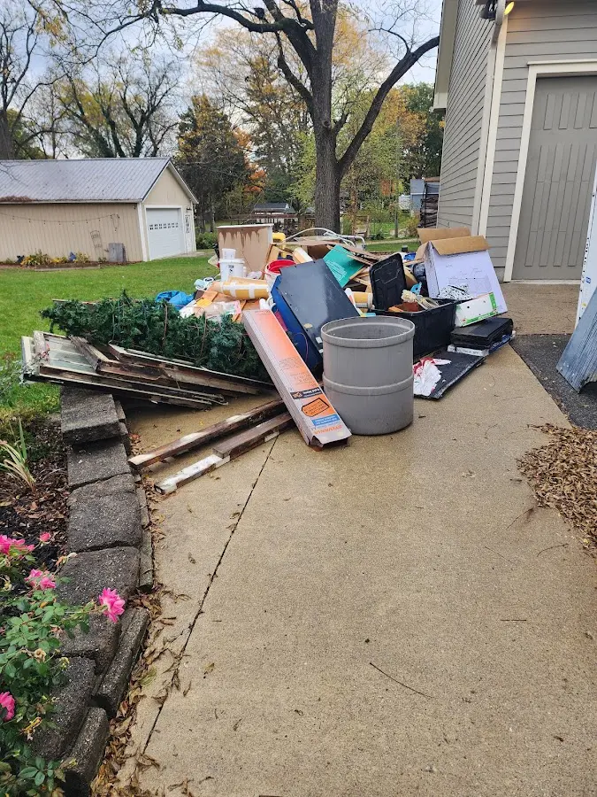 Dumpster being loaded with debris for Demolition Dumpster Rental in Winterset